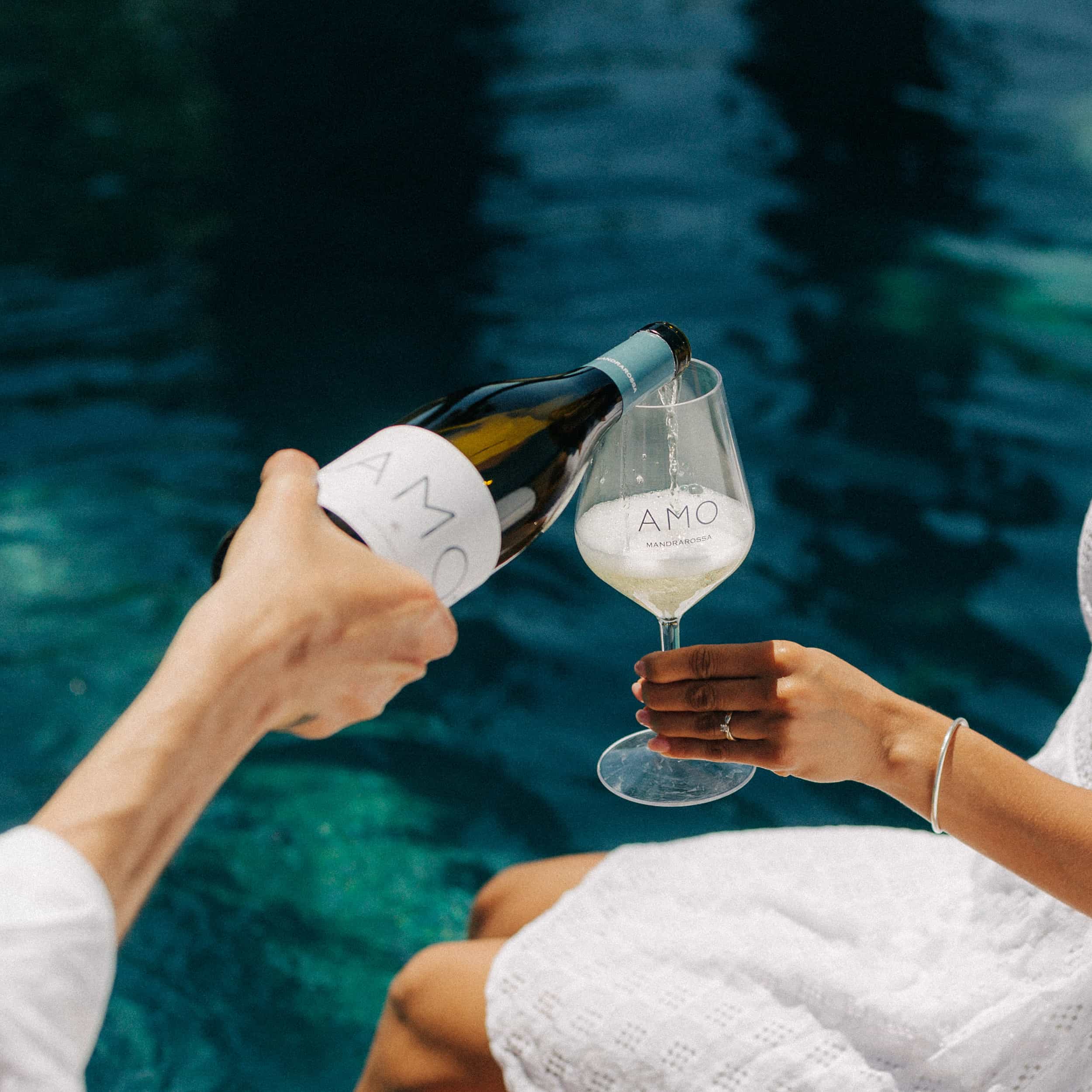 A man serving wine to a girl