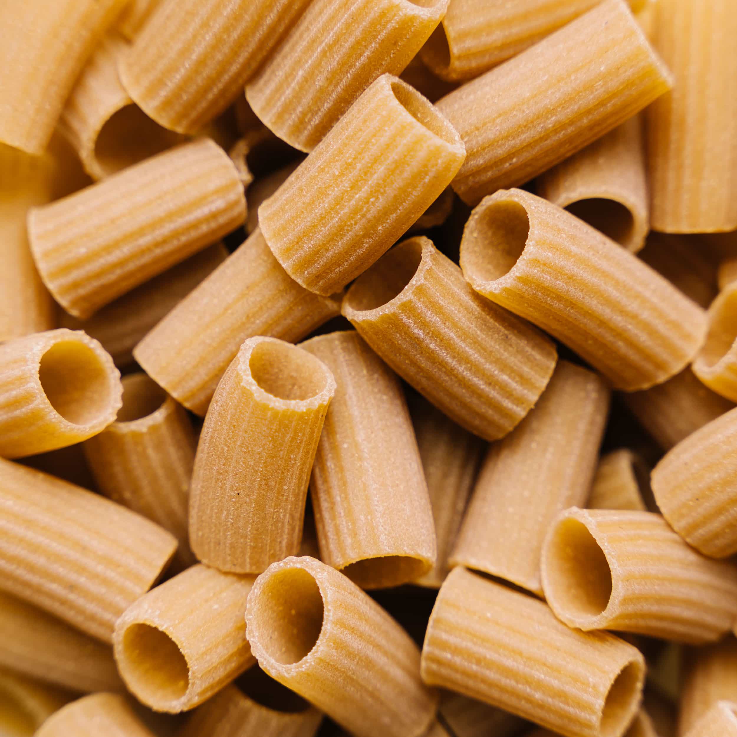 Close-up view of raw, textured pasta stacked together