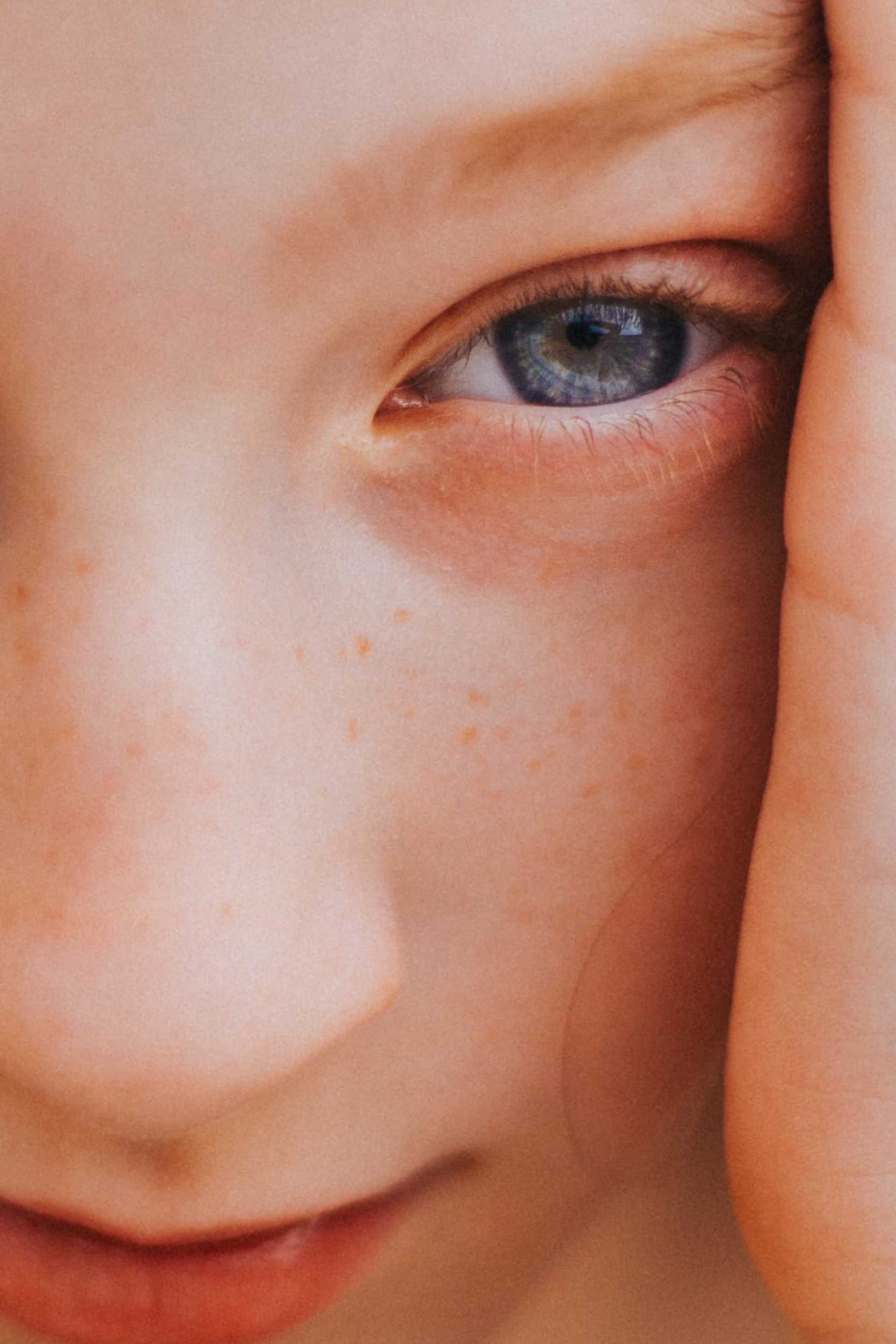 Close-up portrait of a woman with striking blue eyes, fashion photography by Tony Capelli